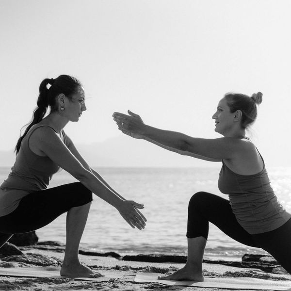 Person stretching outdoors during a beautiful sunrise.